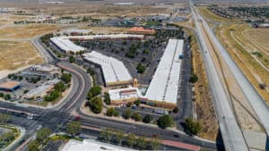 parking and roofs of shopping center with retail/office units for lease in Lancaster, CA